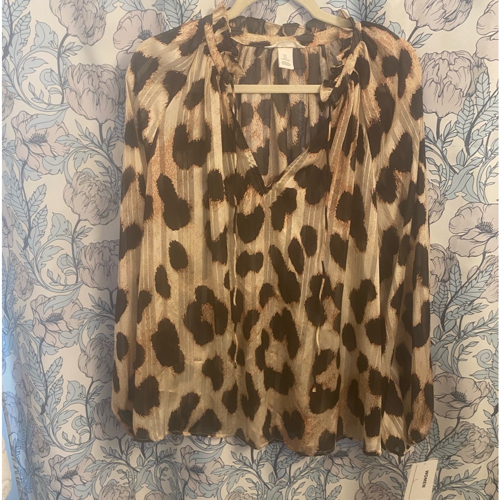 Animal print sheer blouse with neck tie.